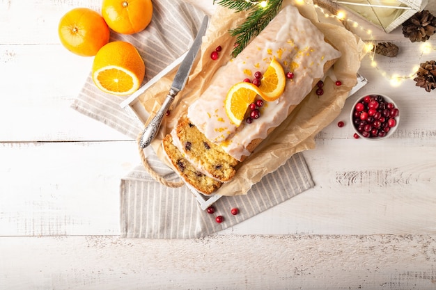 Kerst oranje cake met veenbessen en suikerglazuur op rustieke houten achtergrond