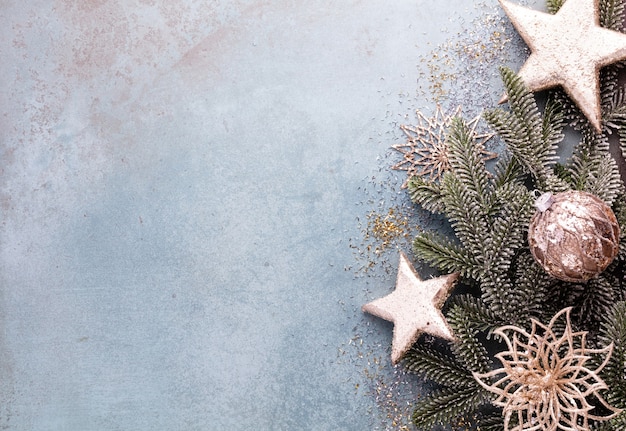 Kerst samenstelling fir tree takken, gouden sterne op blauwe achtergrond.