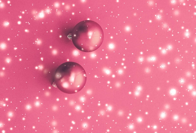 Kerstballen op roze achtergrond met sneeuw glitter luxe winter kerstkaart