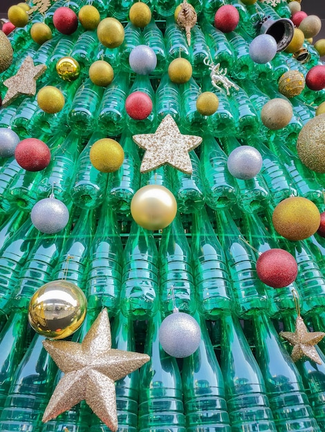 Kerstboom gemaakt van gerecyclede plastic flessen met versieringen