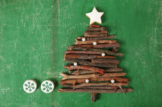 Kerstboom gemaakt van houten takken op houten tafelblad weergave