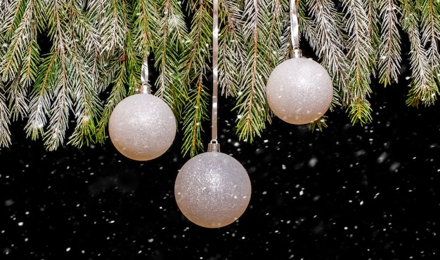 Kerstboom met kerstballen tijdens een sneeuwval