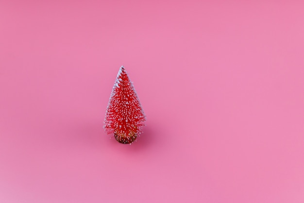 Kerstboom op een pastelroze achtergrond. Kerstmis of Nieuwjaar concept. Minimaal ontwerp