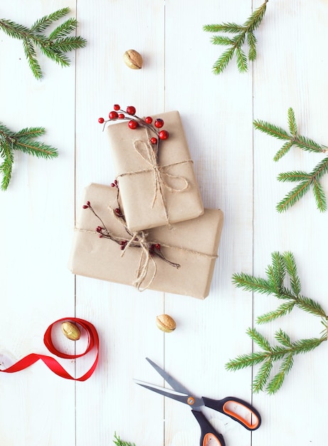 Kerstcadeaudozen en dennenboomtak op houten tafel plat leggen Shristmas-achtergrond