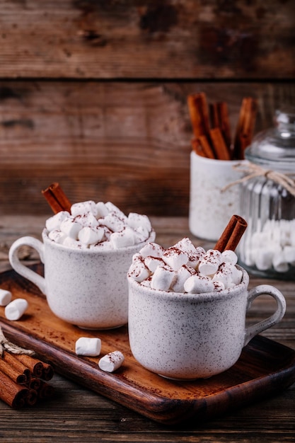 Kerstdrank Warme chocolademelk met marshmallows en kaneel op donkere houten achtergrond