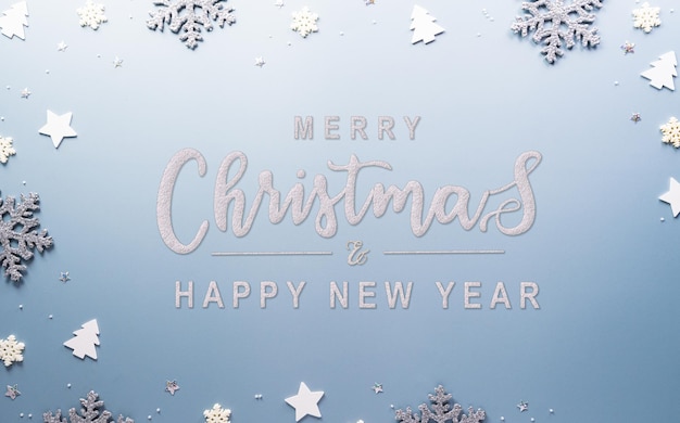 Foto kerstmis en nieuwjaar achtergrondconcept bovenbeeld van kerstster en sneeuwvlok op pastelblauwe achtergrond