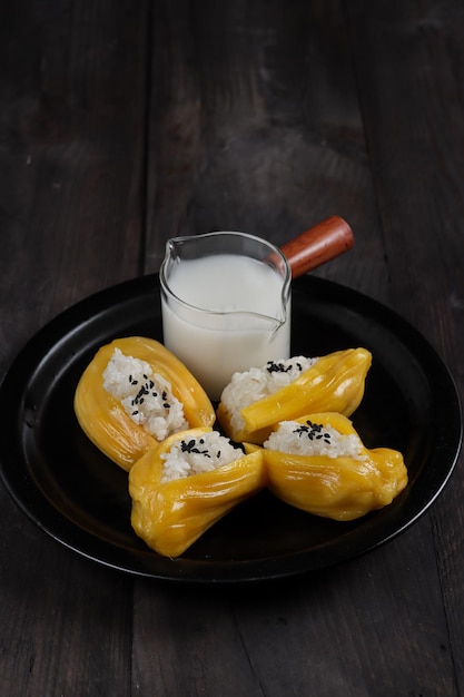 Ketan nangka or Sticky rice in jackfruit topped with coconut milk and sesame seedsThai dessert