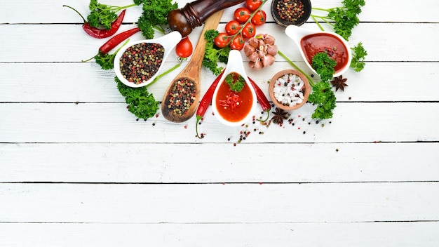 Ketchup barbecue sauce tomato sauce A set of tomato sauces on a white wooden background Top view Free space for your text