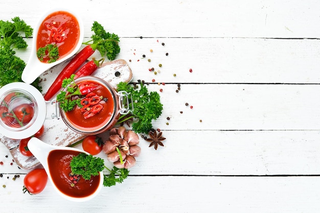 Ketchup barbecue sauce tomato sauce A set of tomato sauces on a white wooden background Top view Free space for your text