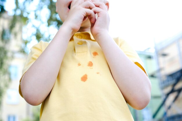 Ketchup stains on a yellow tshirt daily life dirty stain for wash and clean concept