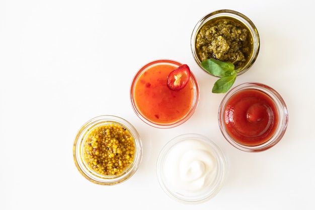 Ketchup, sweet chili sauce, pesto, french mustard and mayonnaise in bowls