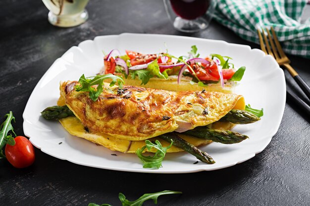 Keto breakfast Omelette with cheese red onion and asparagus on dark table Italian frittata Keto ketogenic lunch