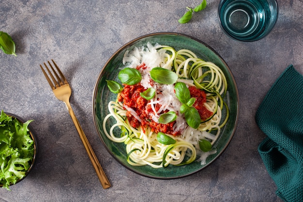 Keto paleo noodles bolognese. zucchini noodles with meat sauce and parmesan