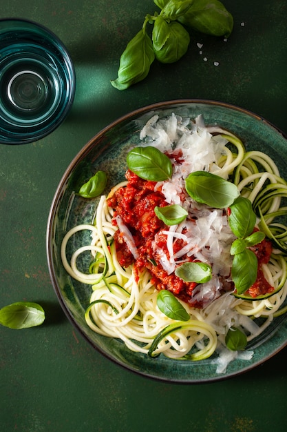 Keto paleo noodles bolognese: zucchini noodles with meat sauce and parmesan