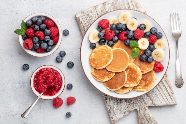 Keto pancakes made of diet flour or almond flour, served with berries.