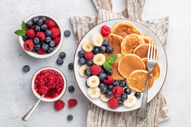 Keto pancakes made of diet flour or almond flour, served with berries.