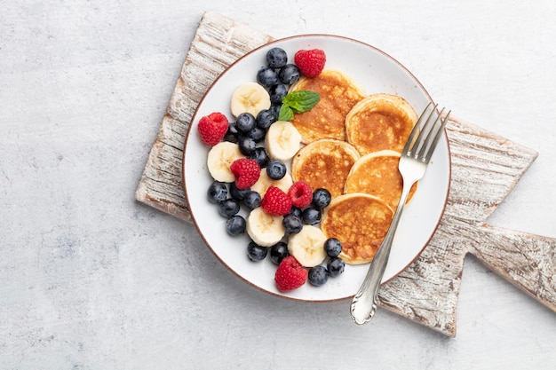 Keto pancakes made of diet flour or almond flour, served with berries.