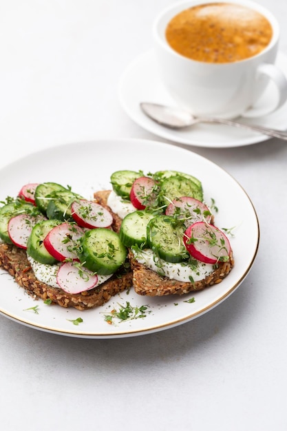 Photo keto toasts with cucumber egg mozzarella and microgreens