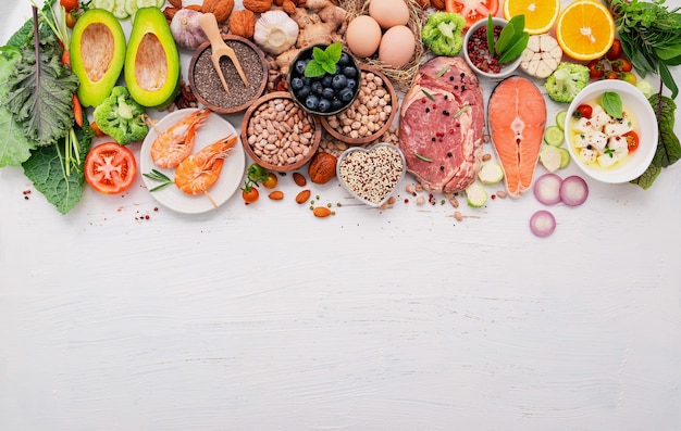 Ketogenic low carbs diet concept. Ingredients for healthy foods selection set up on white wooden background.