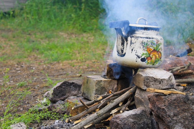 Kettle over burning campfire