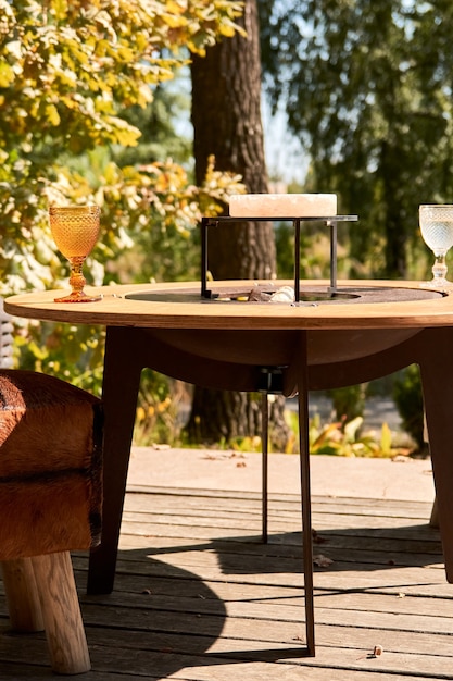 Kettle Grill Pit with Cast Iron Grid with flames . Round table-cooking surface. Hot BBQ on Backyard