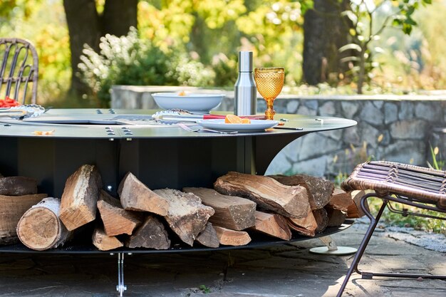 Kettle grill pit with cast iron grid with flames  round tablecooking surface hot bbq on backyard
