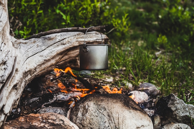 Photo kettle hanging over fire