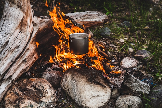 Kettle hanging over fire.