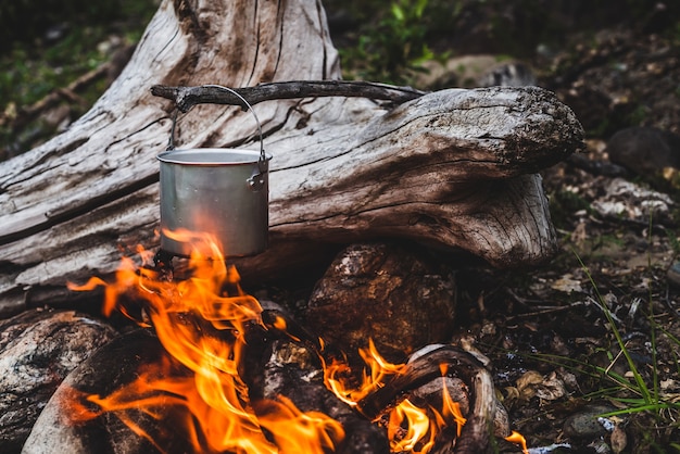 Kettle hanging over fire.