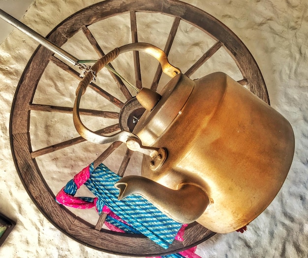 Photo kettle hanging from ceiling by wheel