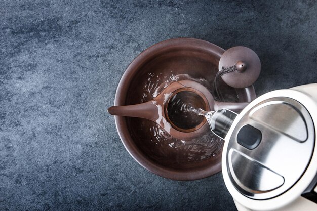 Photo kettle for tea ceremony on a blue stone table