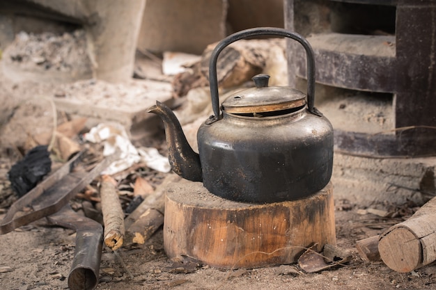 Kettle on a wooden cutting board in the  old kitchen,Local kitchen thailand