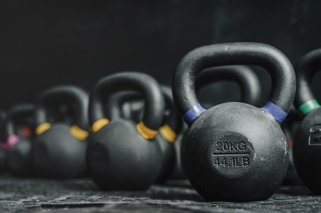 Kettlebells equipment on dark backgroud at the crossfit gym. Sport concept. Copy space