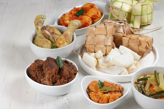 Ketupat Lebaran served with sambal goreng opor ayam sayur labu siam rendang and telur balado