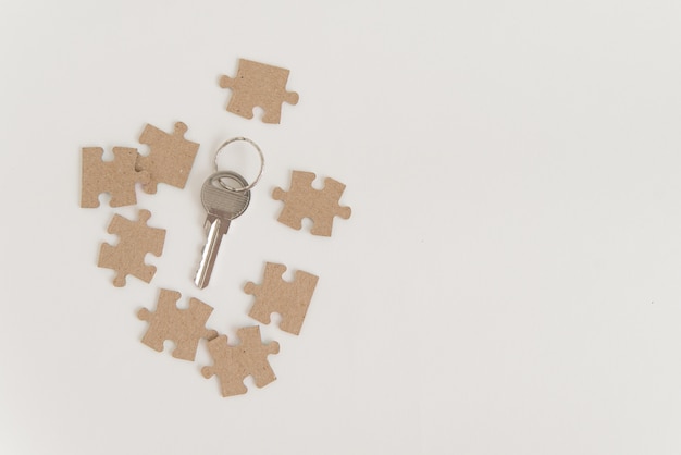 Key and eight pieces of jigsaw puzzle