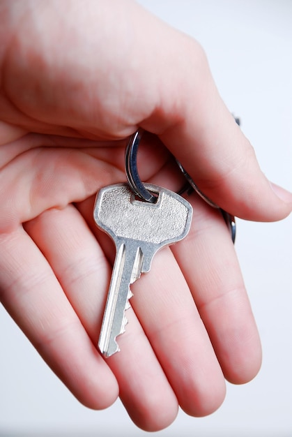 Key from house in hand at white background