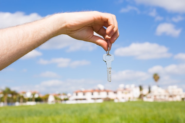 Key in hand for new home and real estate concept of housewarming tenant and new house