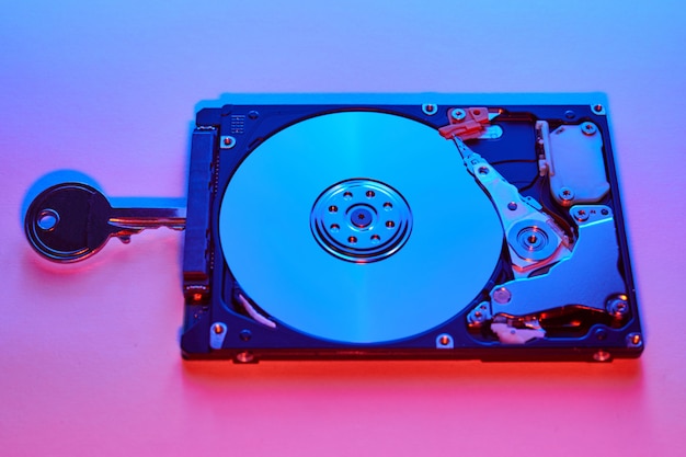 Key in a hard disk on a blue and pink background