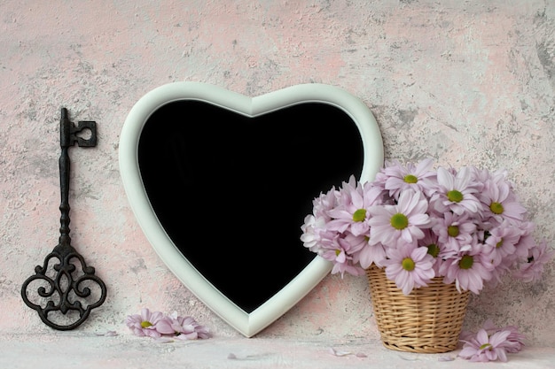 Photo key heart board and bouquet of chrysanthemums