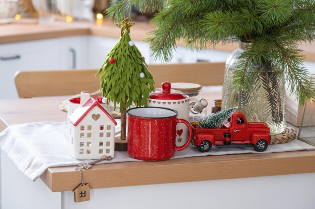 Key to the house on cozy home with Christmas decor on table of festive kitchen Gift for New Year Building design project moving to new house mortgage rent and purchase real estate