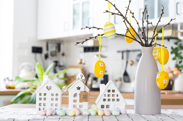 Key to house of cozy home with Easter decor with rabbit and eggs on table of kitchen Building design project moving to new house mortgage insurance rent and purchase real estate