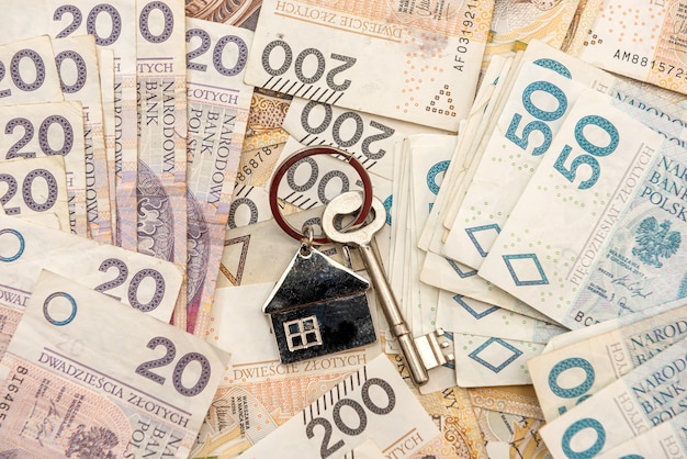 Key for the house lyi on polish money, pln. real estate concept