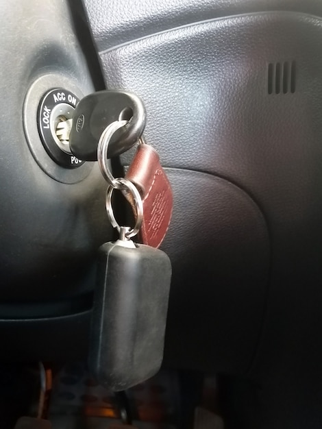 The key in the ignition with the car\'s signal key fob\
close-up.