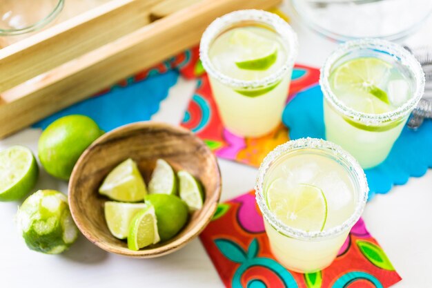 Key lime margarita garnished with fresh lime in mason jar.