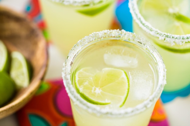 Photo key lime margarita garnished with fresh lime in mason jar.