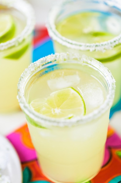 Key lime margarita garnished with fresh lime in mason jar.