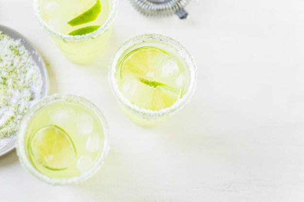 Key lime margarita garnished with fresh lime in mason jar.