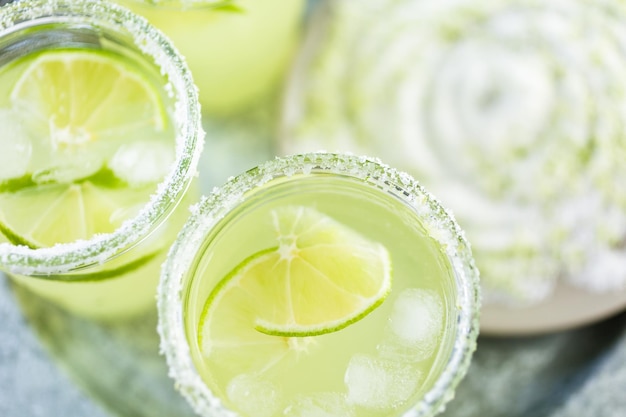 Key lime margarita garnished with fresh lime in mason jar.