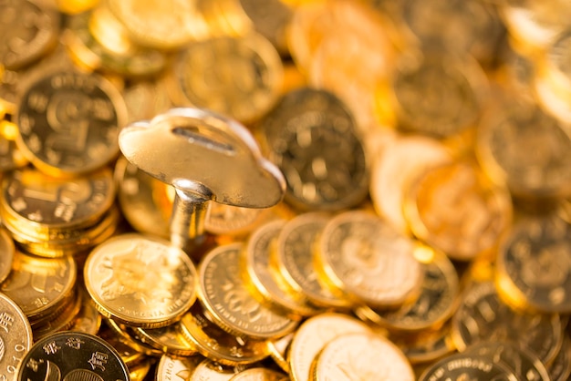 A key in a pile of gold coins