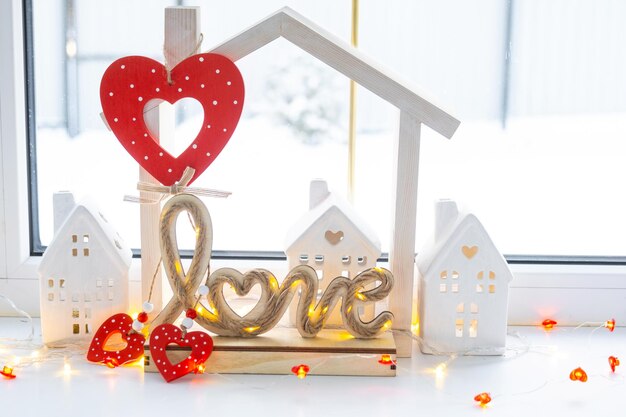 Photo key to tiny house of cozy home with valentine decor on the windowsill gift for valentines day family love nest design project moving to new house mortgage rent and purchase real estate